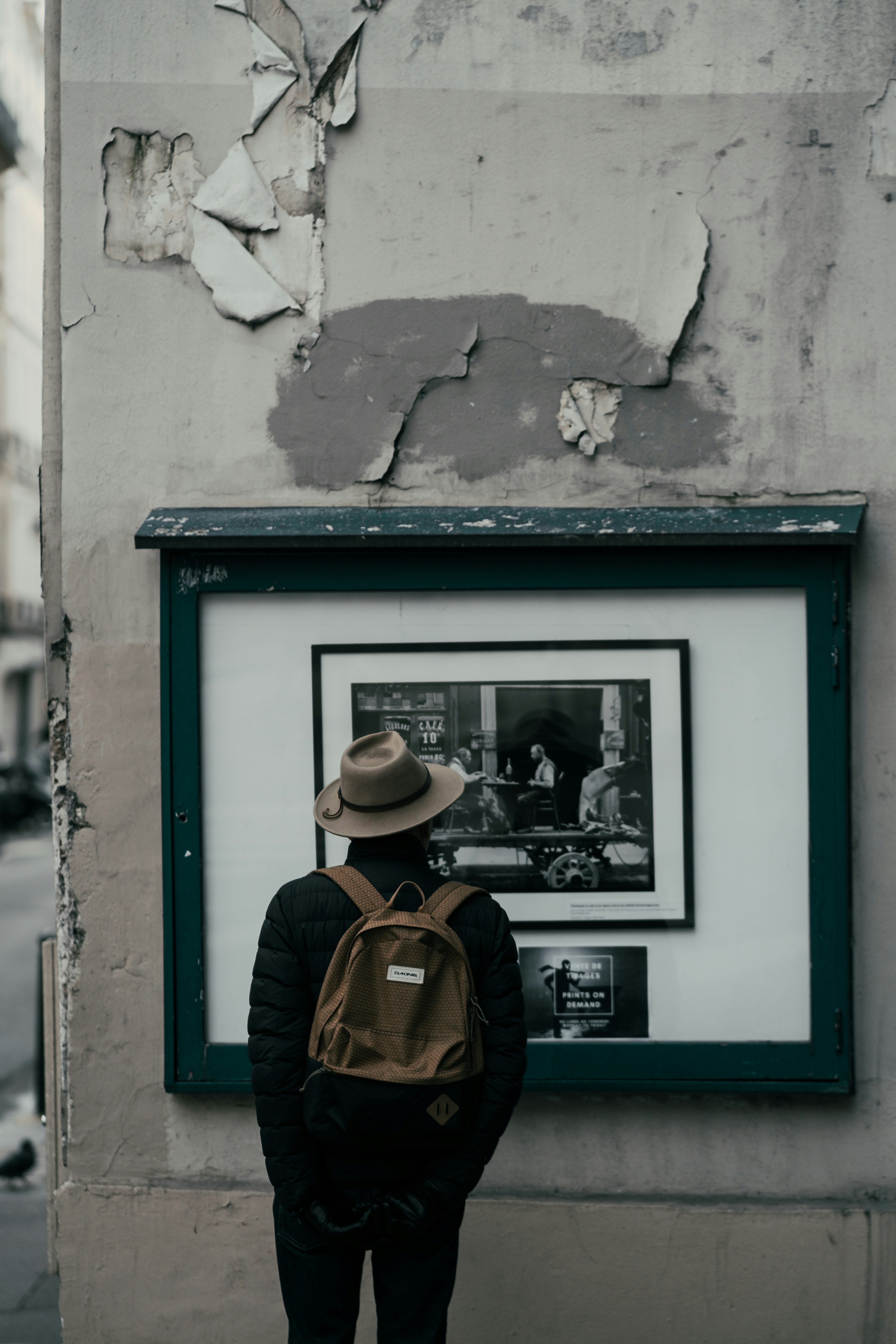 Man looking at photos in the street in Paris