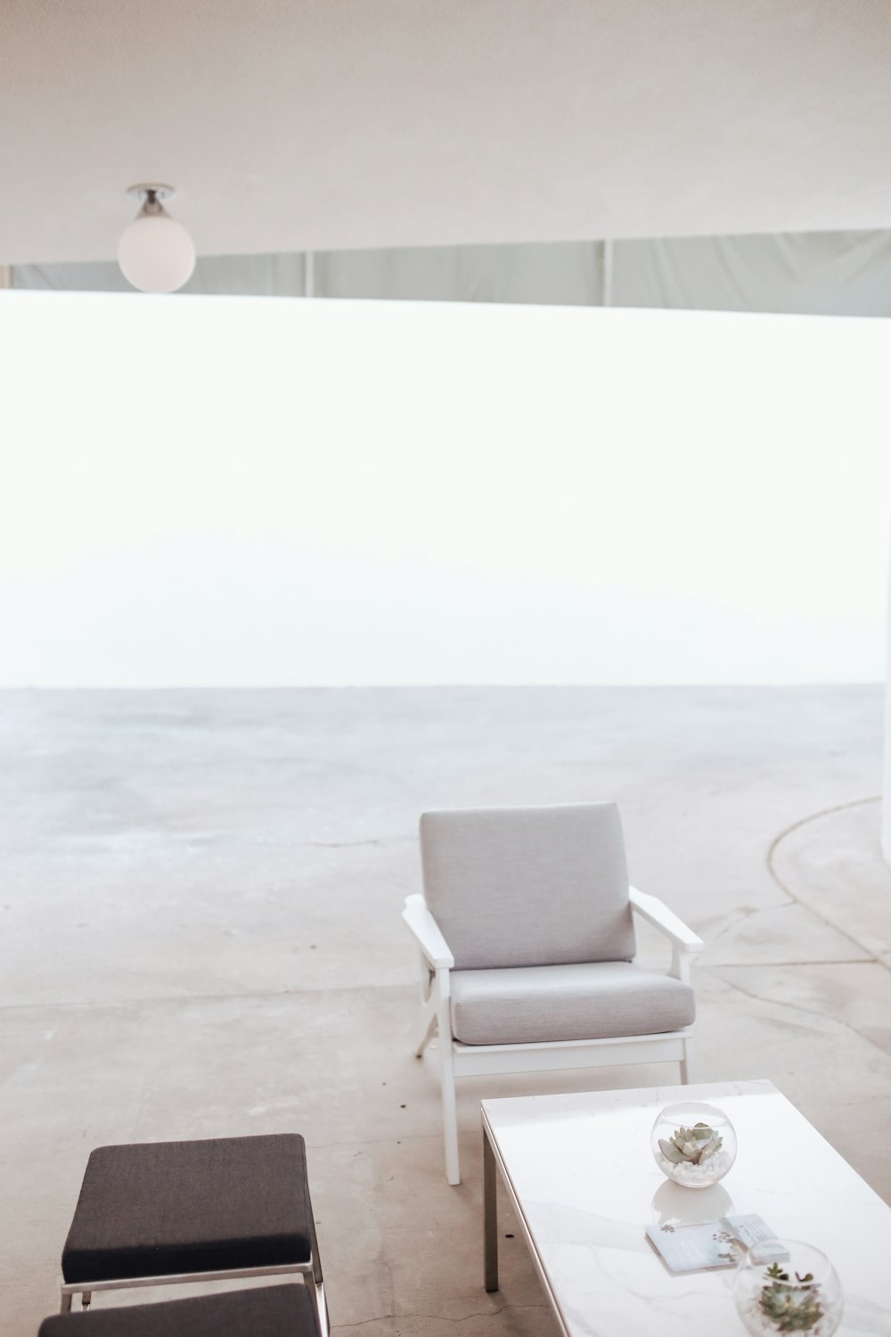 white and gray armchair on gray carpet