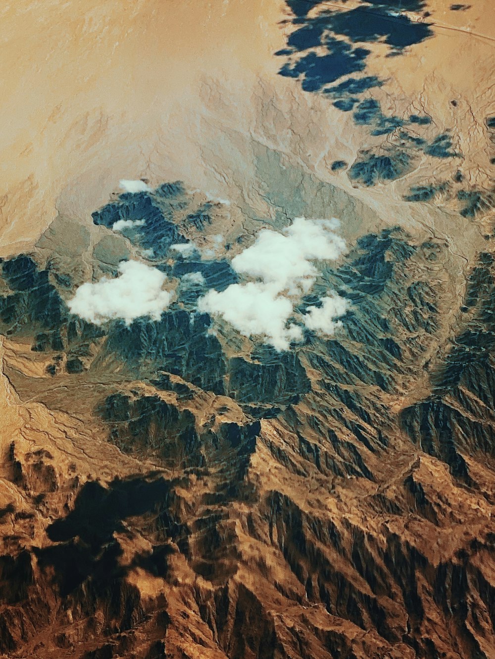 brown and gray mountains under white clouds during daytime