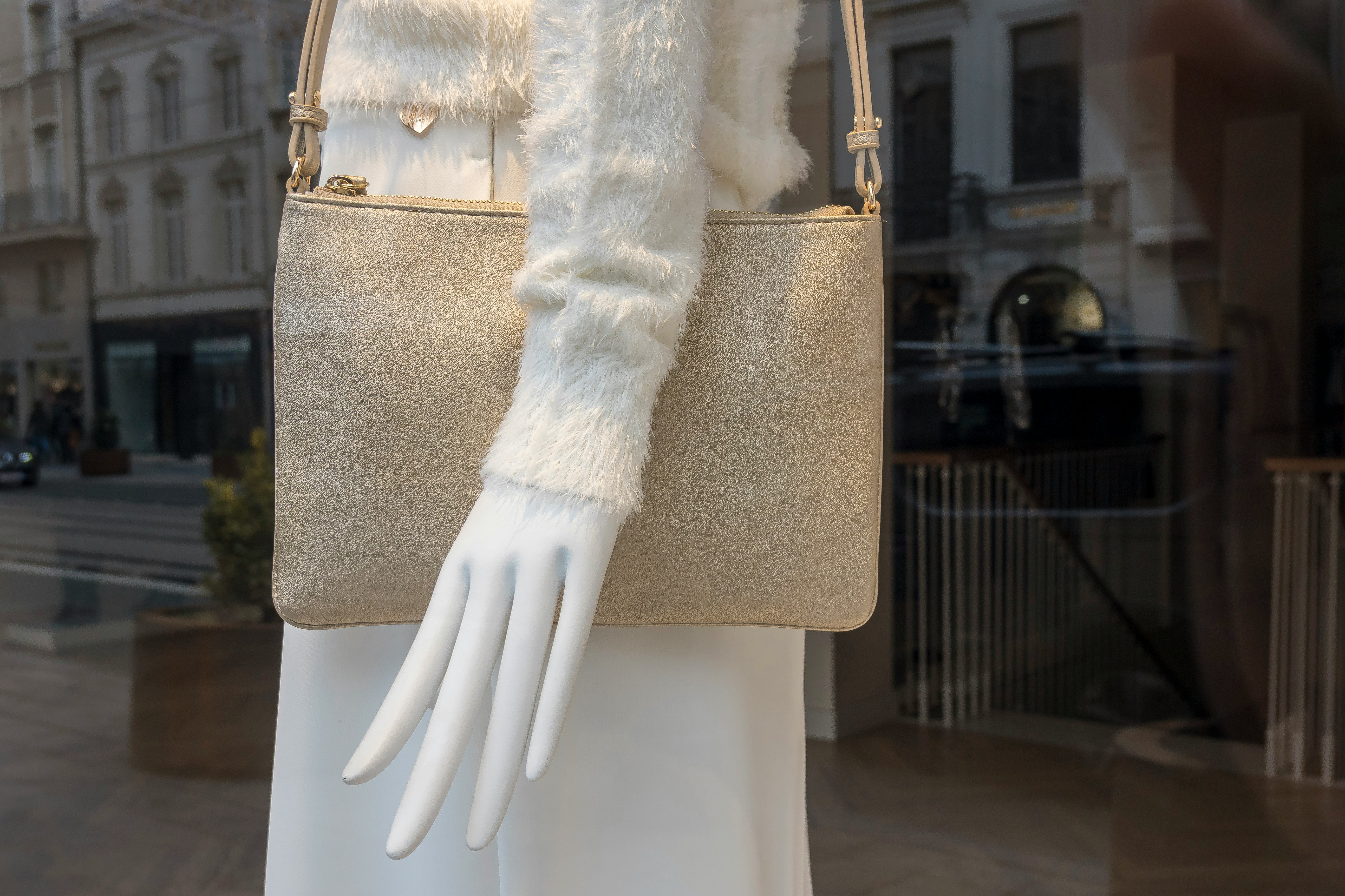 woman in white fur coat and white pants