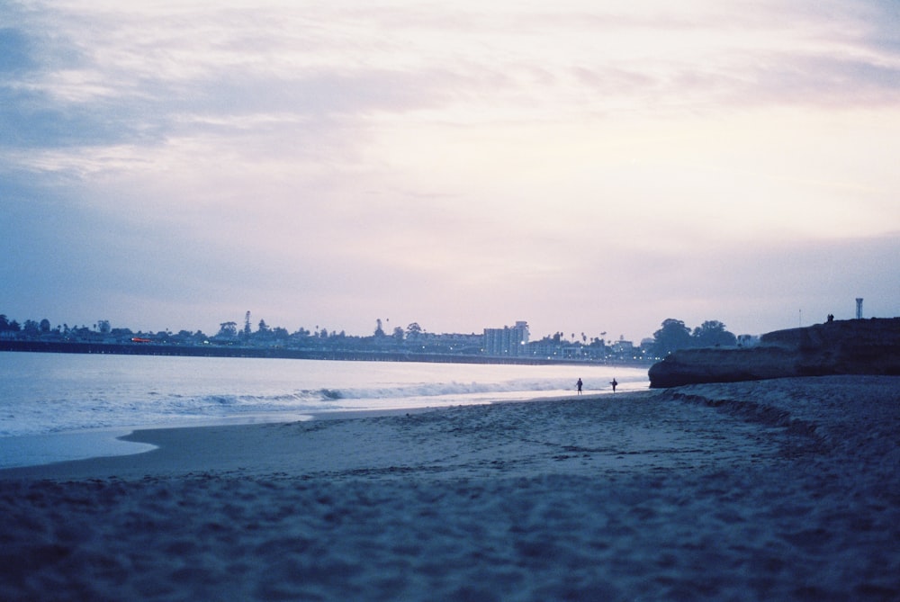 body of water under cloudy sky during daytime