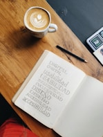 white ceramic mug on brown wooden table