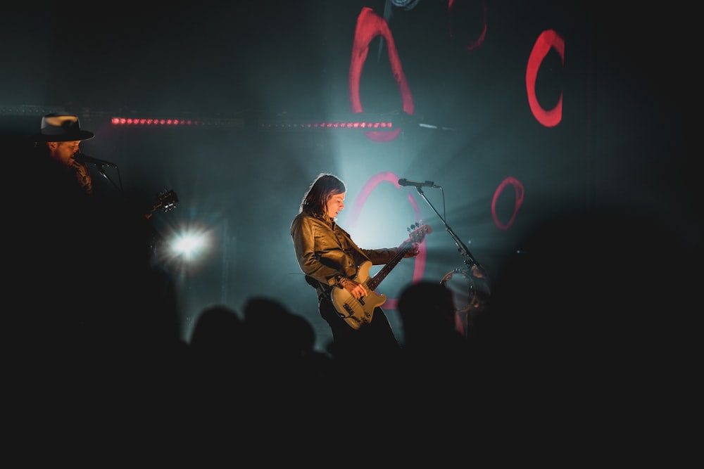 man playing guitar on stage