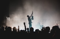 Guitarist striking a powerful pose with the St. Louis skyline glowing behind.