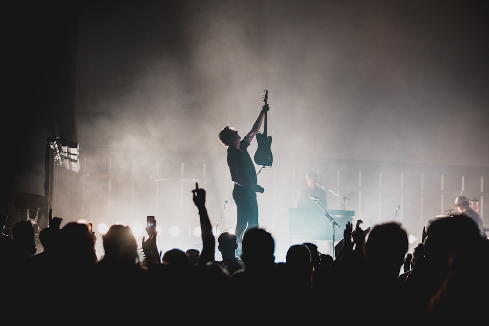 people standing on stage during night time