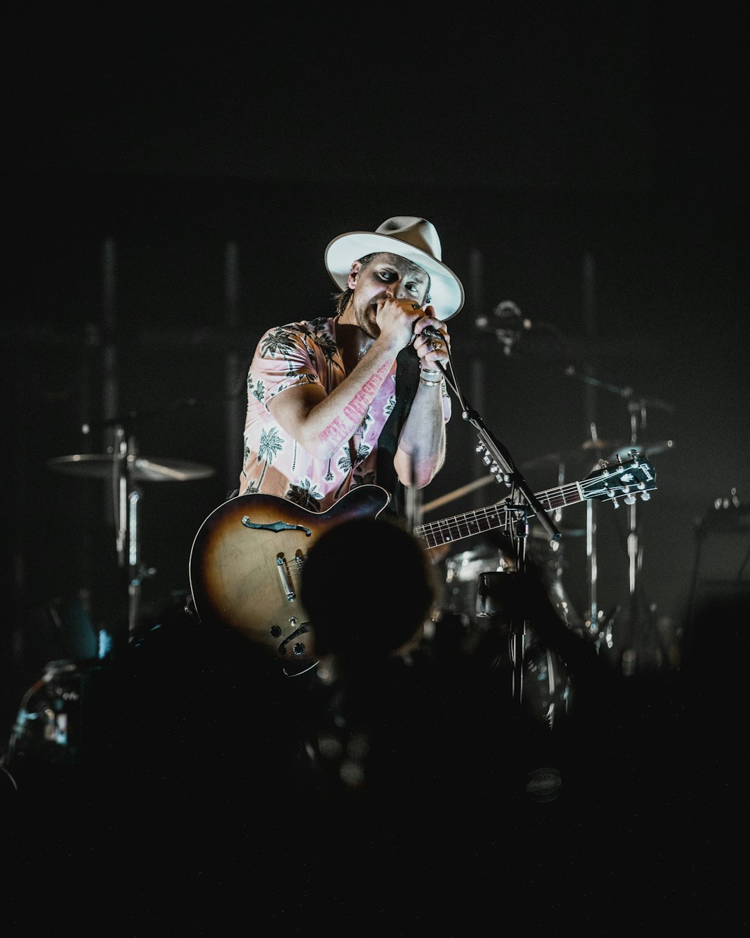 man in white cowboy hat playing guitar