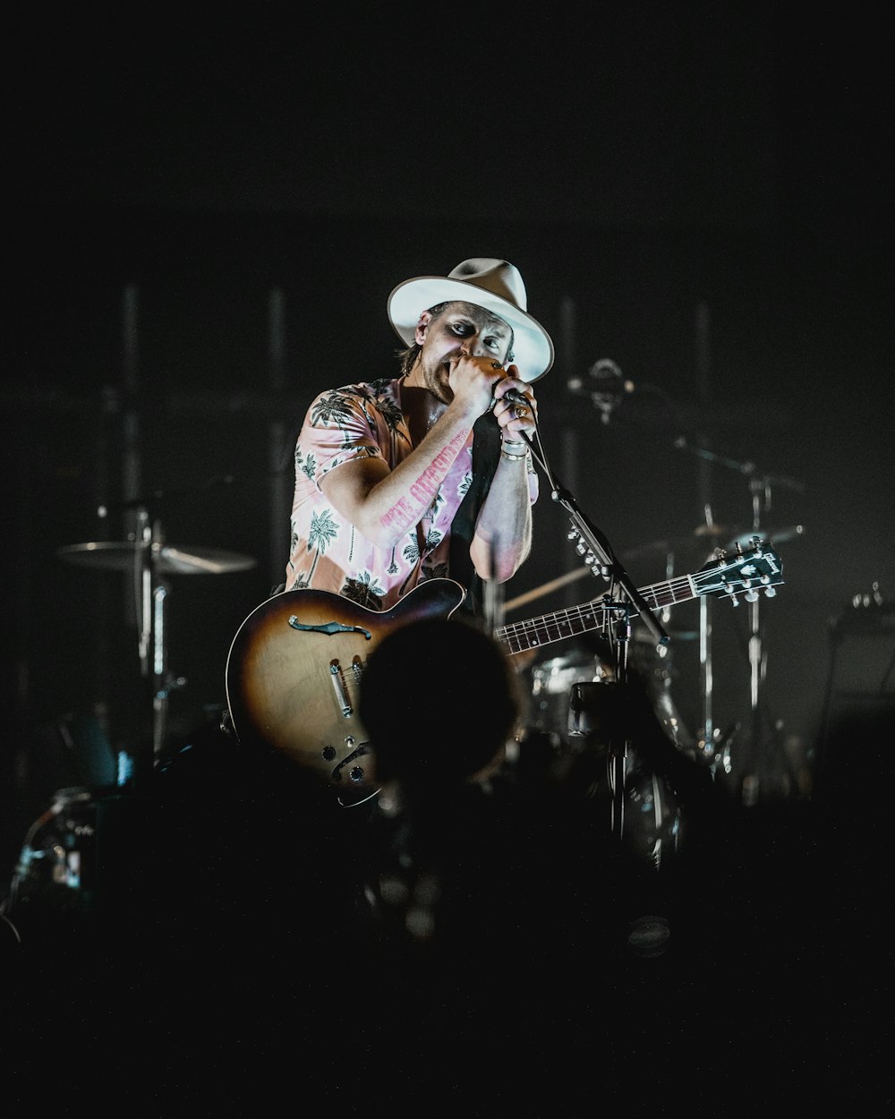 man in white cowboy hat playing guitar