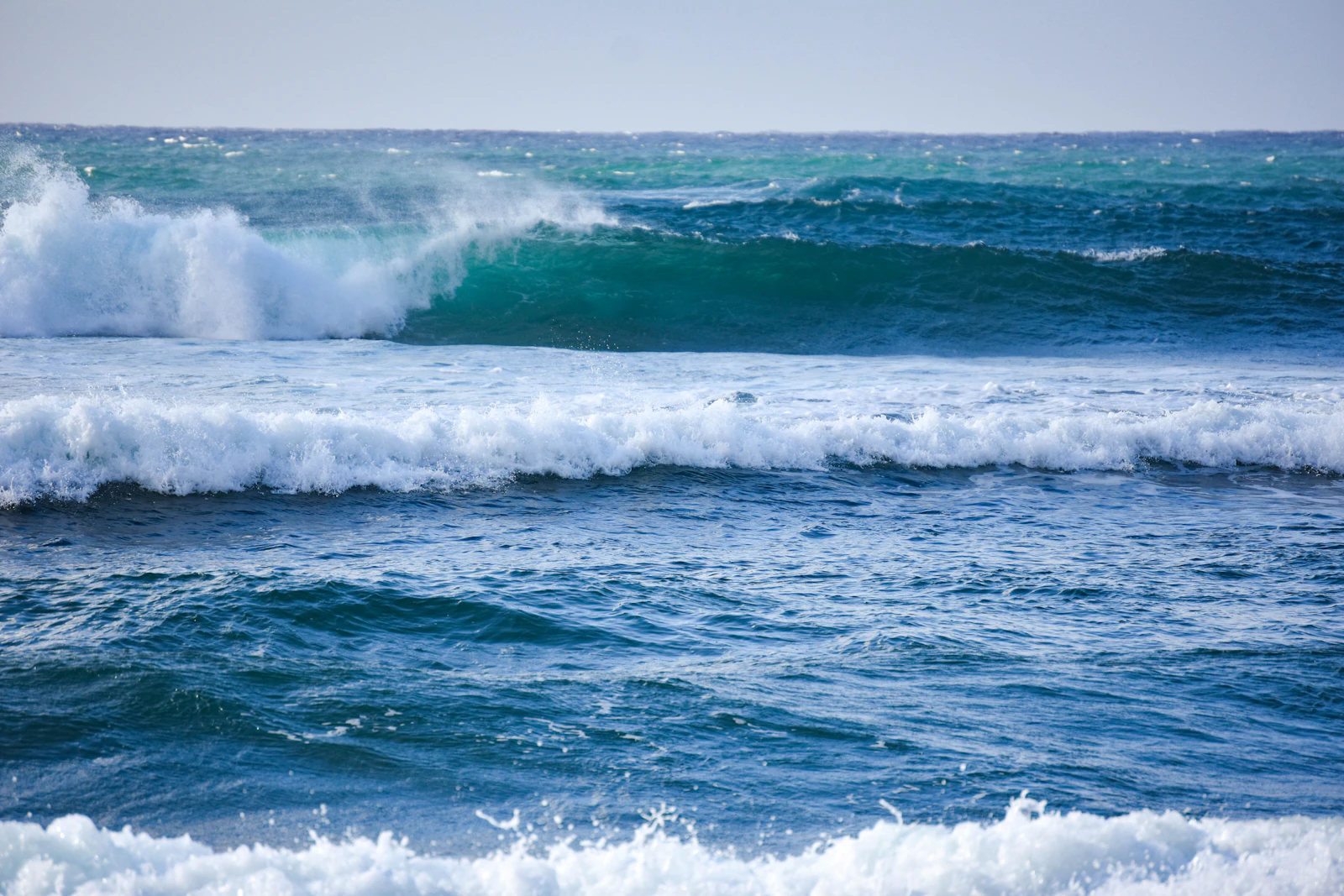 Ocean waves crashing on shore during daytime