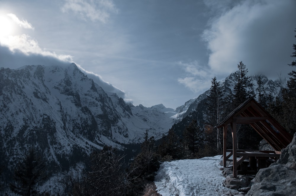 snow covered mountains under cloudy sky during daytime