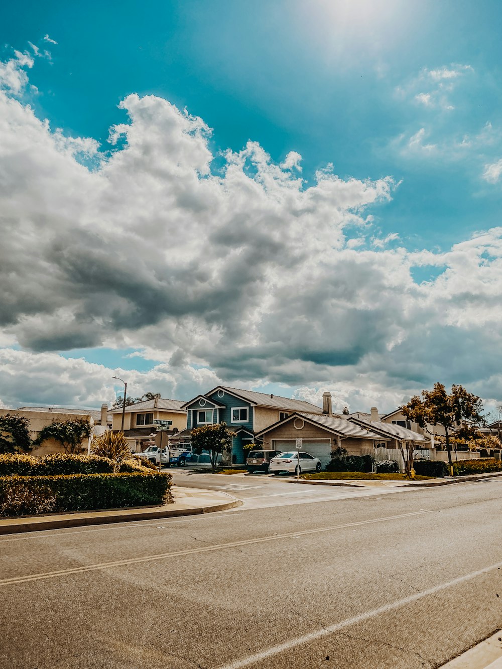 blue and white house under white clouds and blue sky during daytime