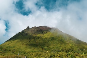 green mountain under white clouds during daytime
