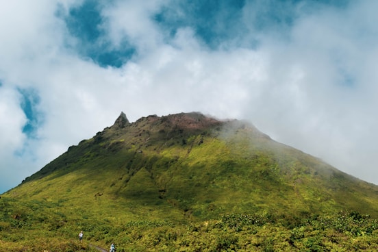 green mountain under white clouds during daytime
