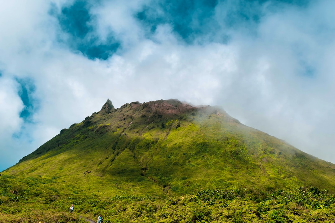 green mountain under white clouds during daytime