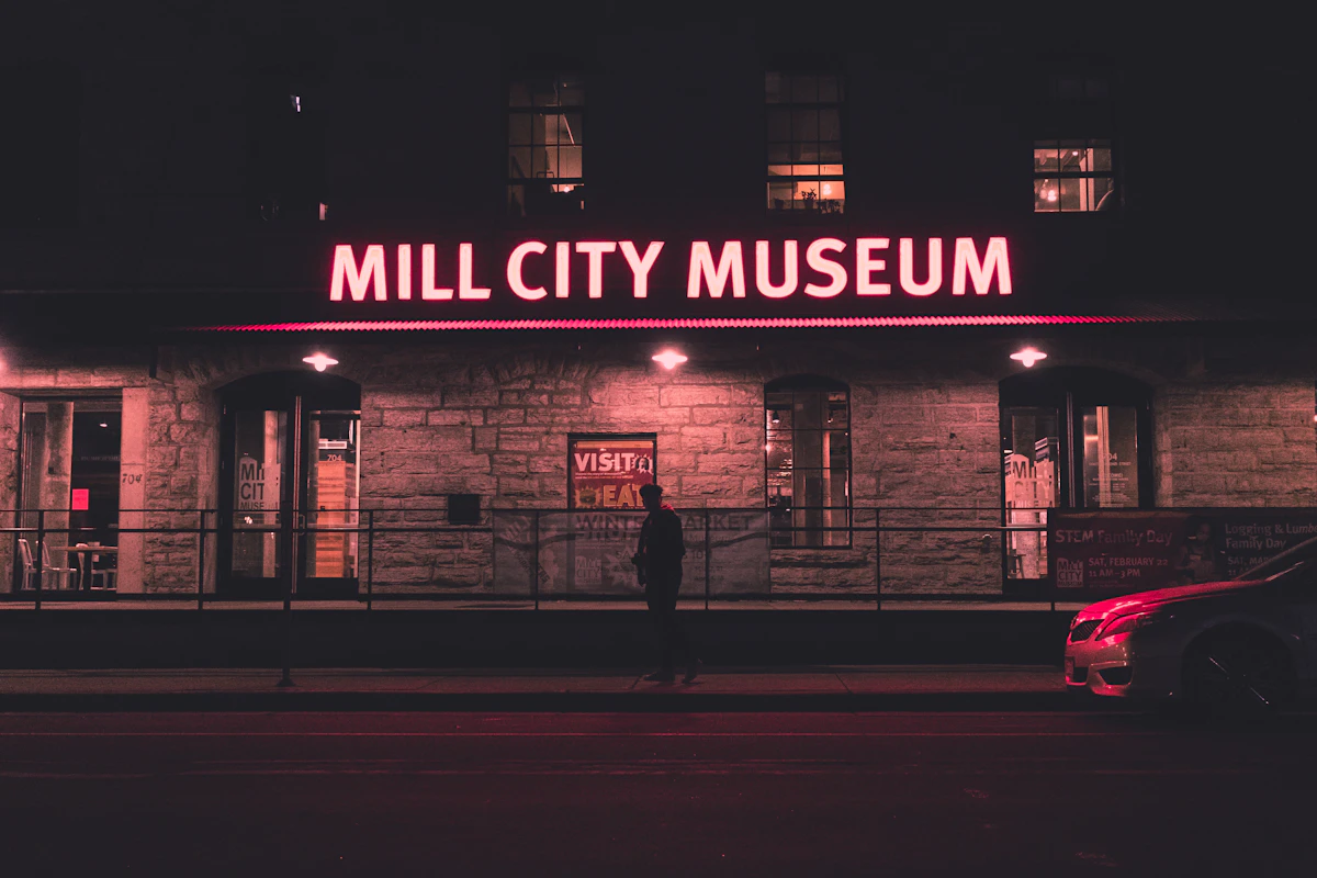Illuminated Mill City Museum sign and brick facade in Minneapolis at night