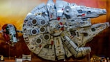 A Lego spaceship model displayed against a starry background.