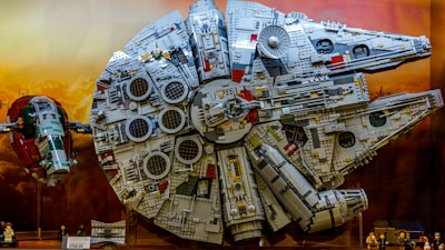 A Lego spaceship model displayed against a starry background.
