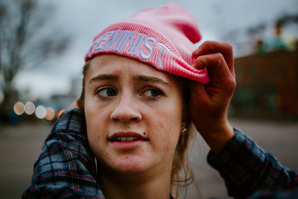 woman in red and white knit cap