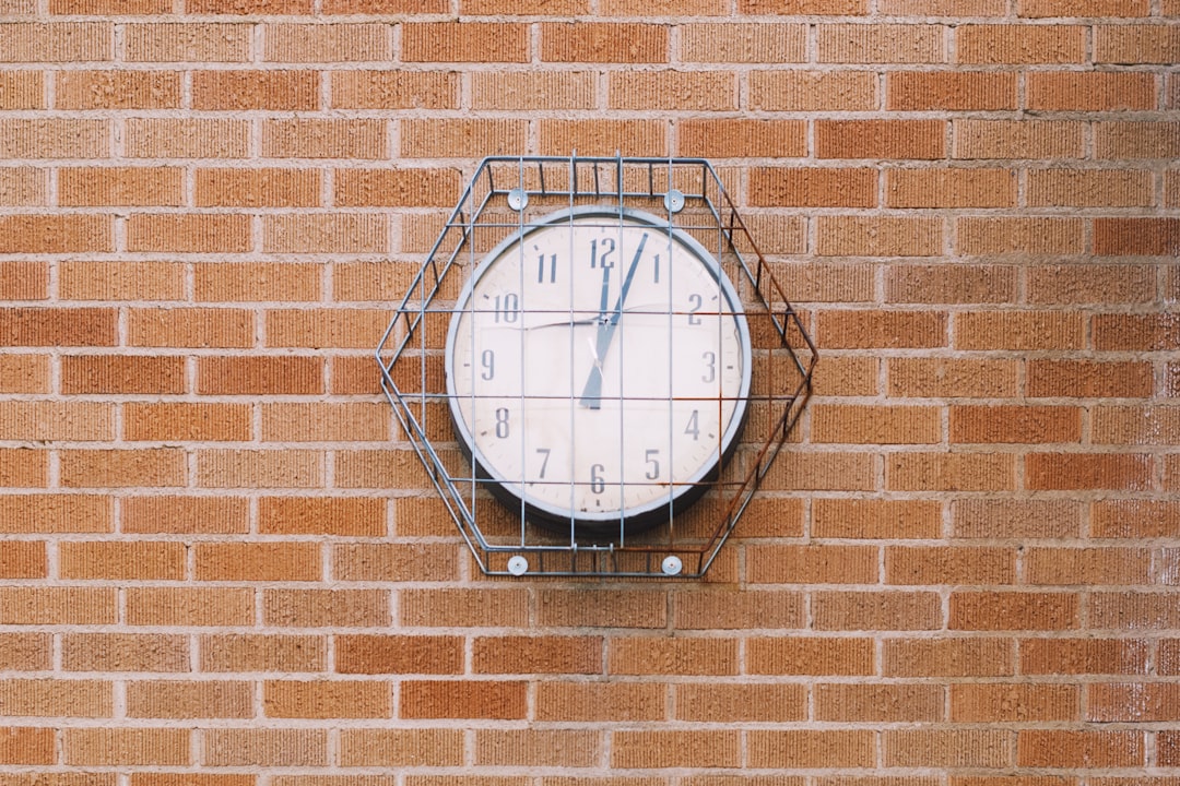 silver round analog wall clock