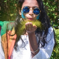 woman in white and red shirt wearing blue sunglasses