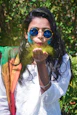 woman in white and red shirt wearing blue sunglasses