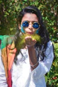 woman in white and red shirt wearing blue sunglasses