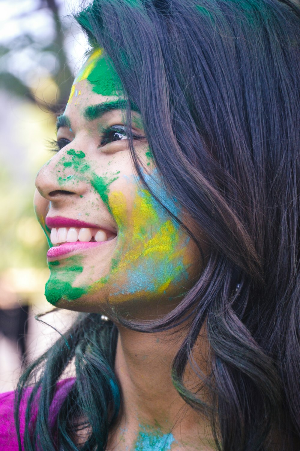 woman with blue and green face paint