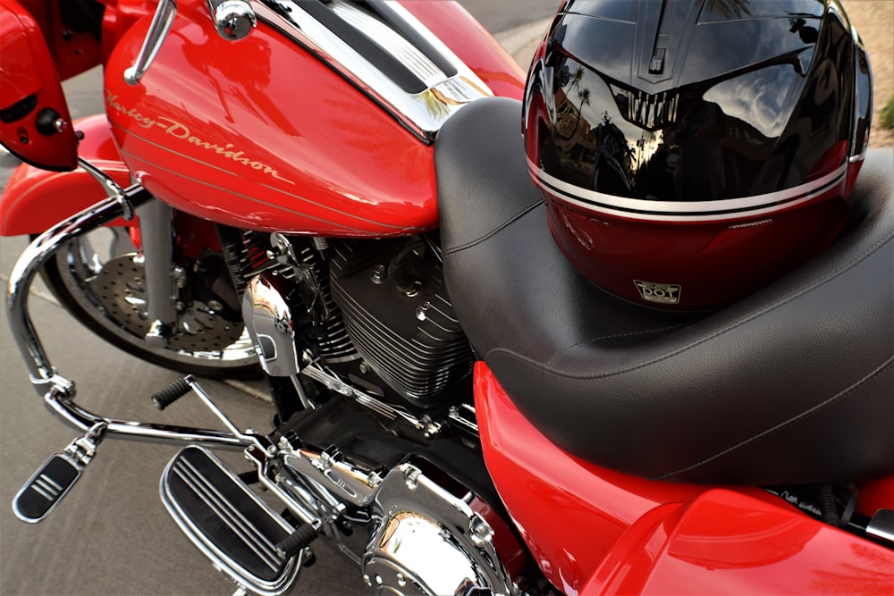 red and black motorcycle near white and red cars