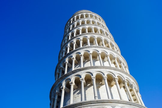 white concrete building under blue sky during daytime in Piazza dei Miracoli Italy