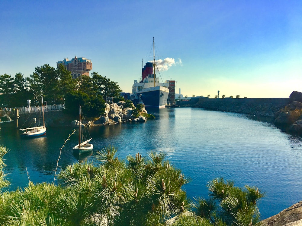 white boat on body of water near city buildings during daytime