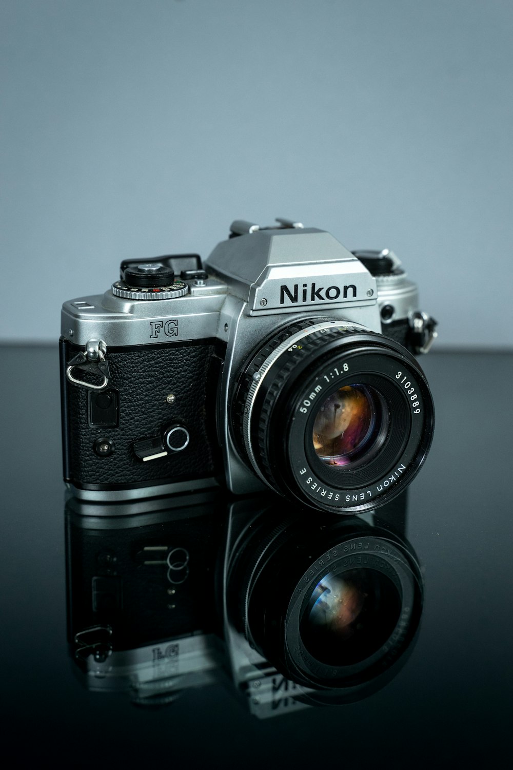 black nikon dslr camera on white table