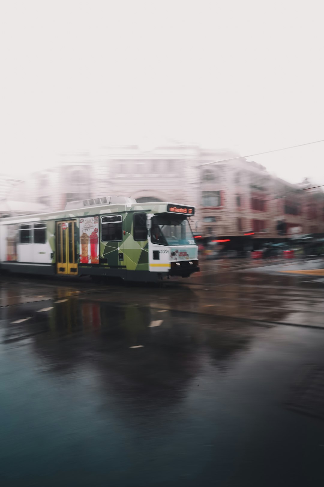 green and white tram on road during daytime