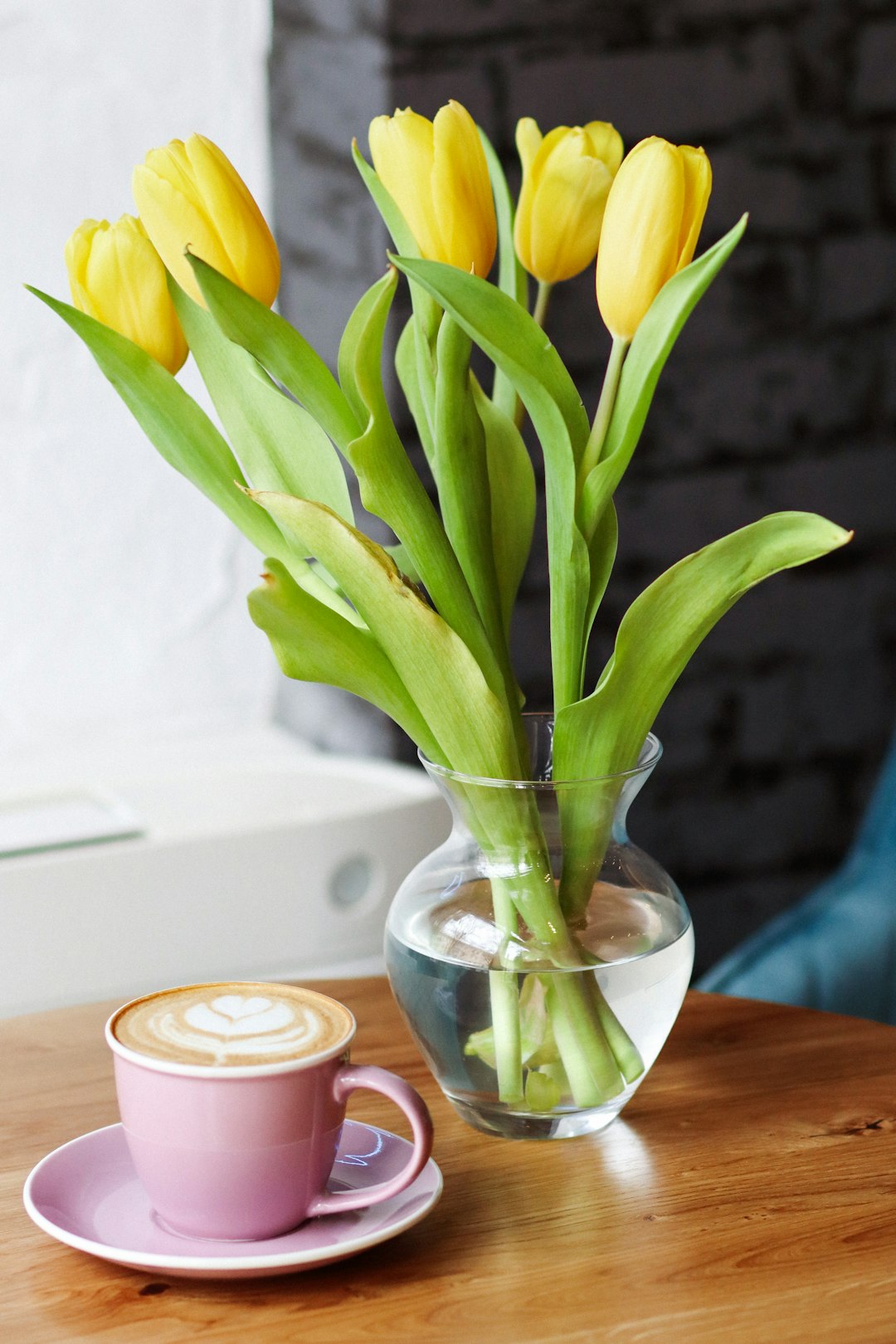 yellow tulips in clear glass vase