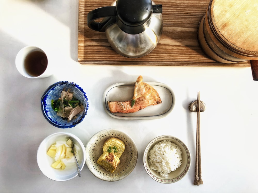 white ceramic plate with food on brown wooden tray