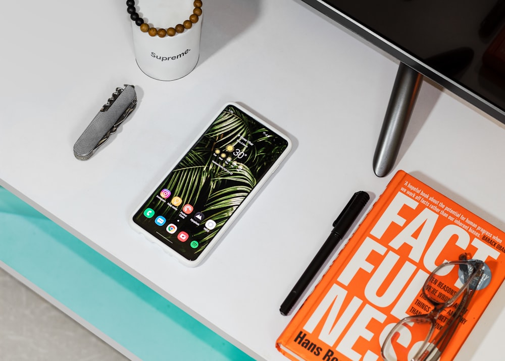 black iphone 7 beside black click pen