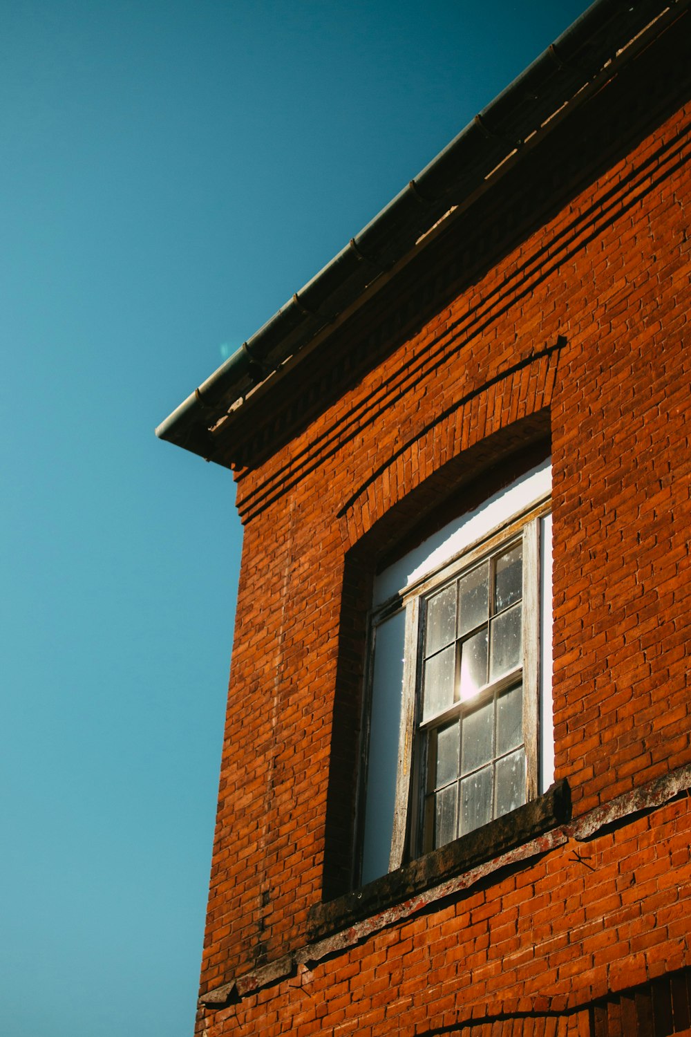 brown brick building with white wooden window