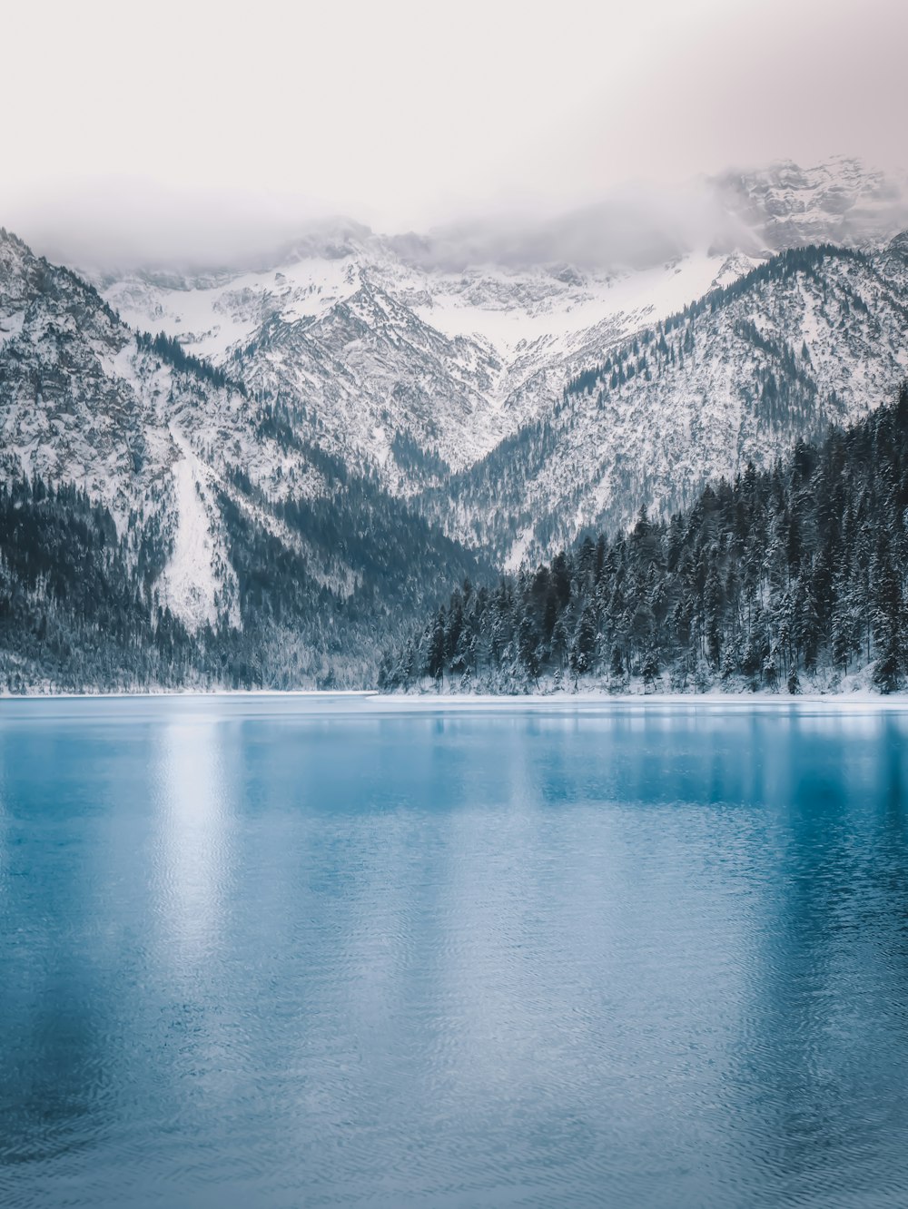 lake near mountain range during daytime