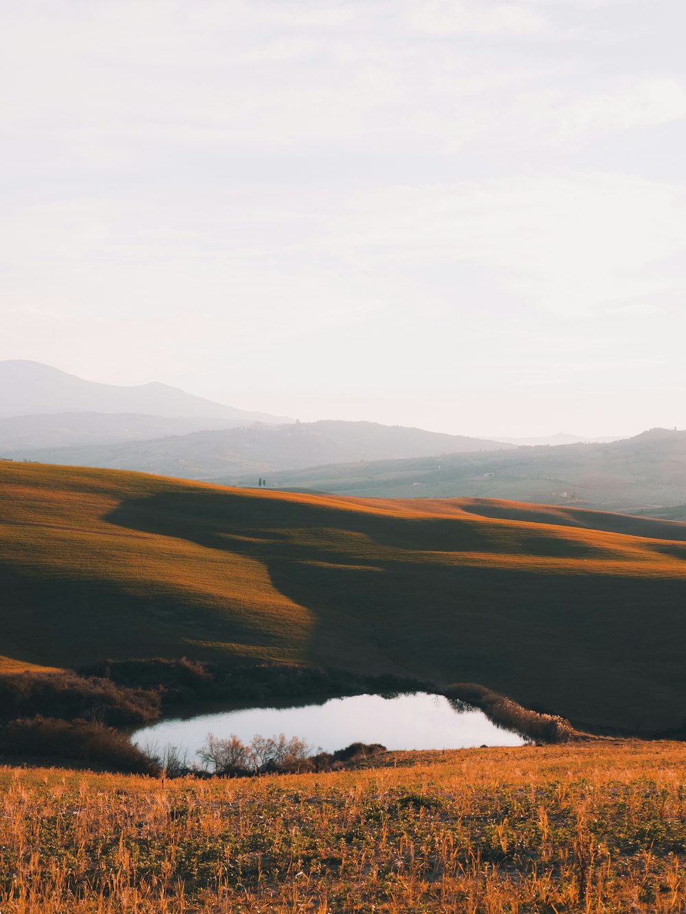 brown and green mountains under white sky during daytime