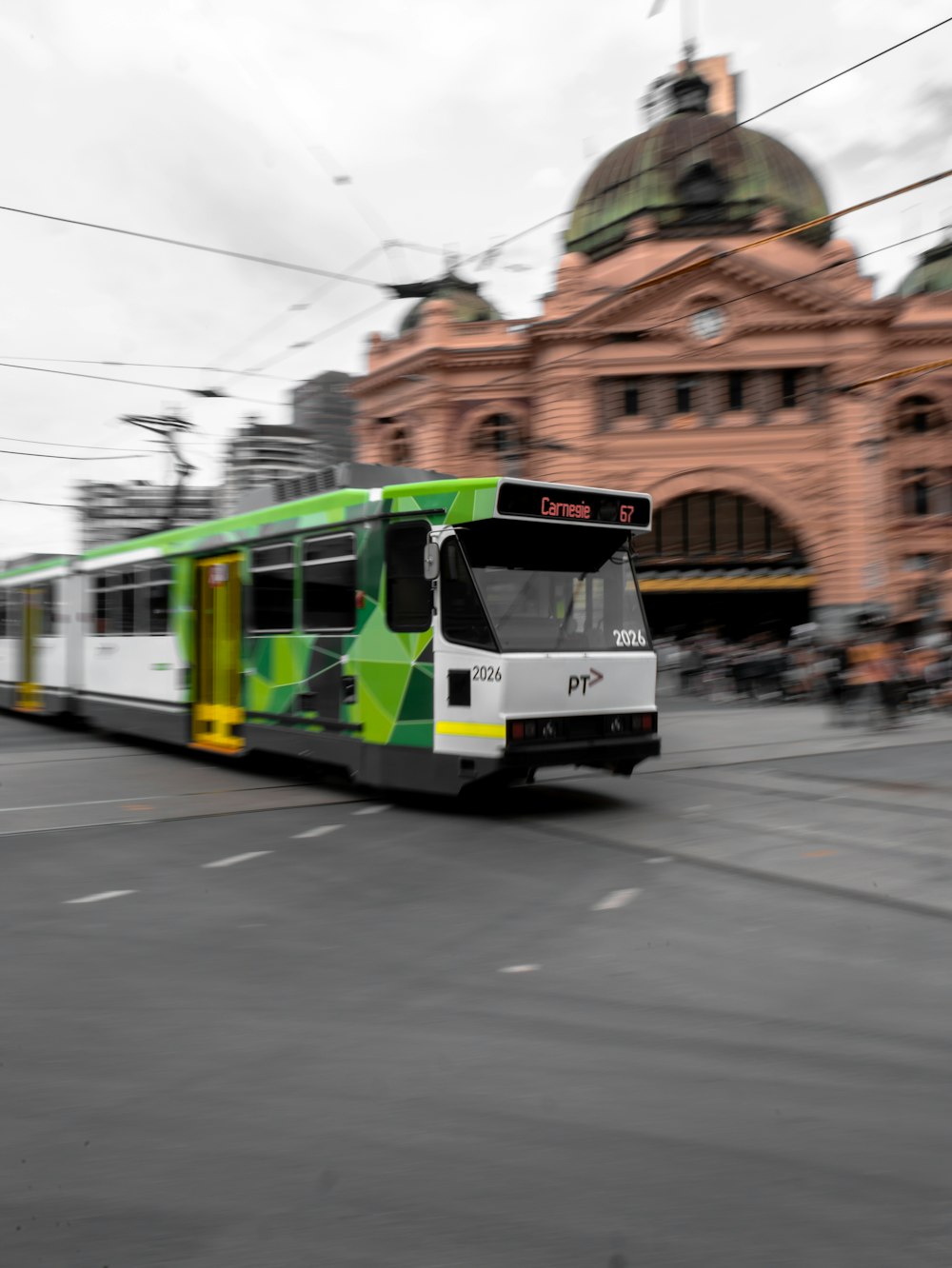 white and green tram on road during daytime