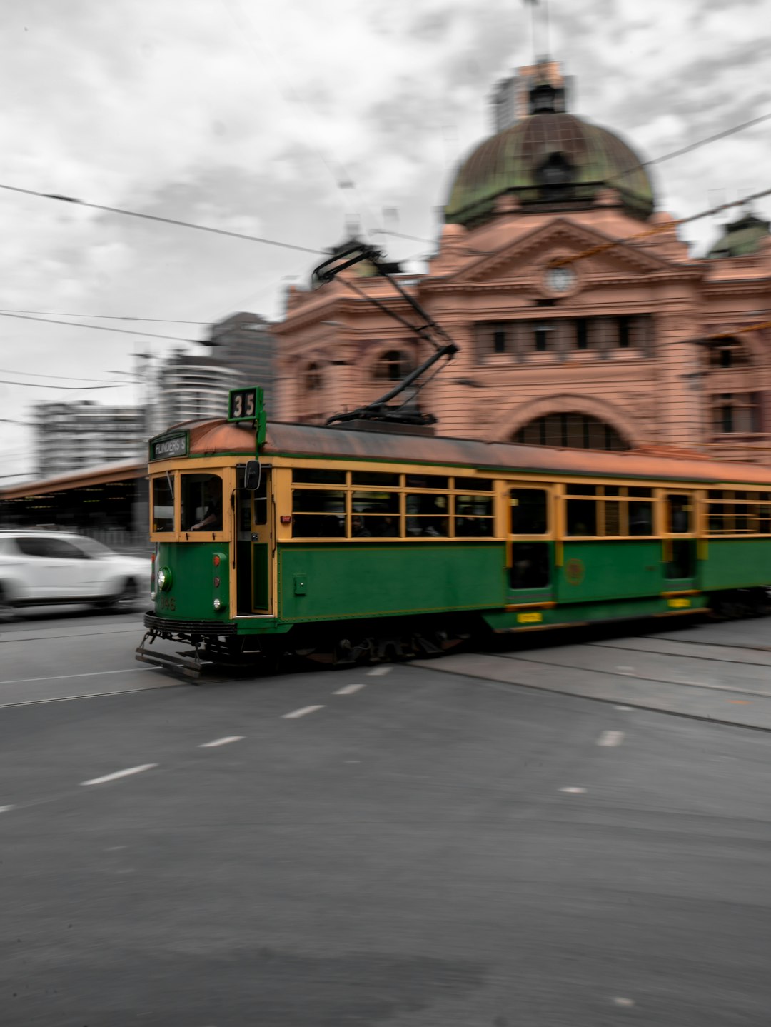 green and yellow tram on road during daytime