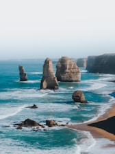 brown rock formation on sea during daytime