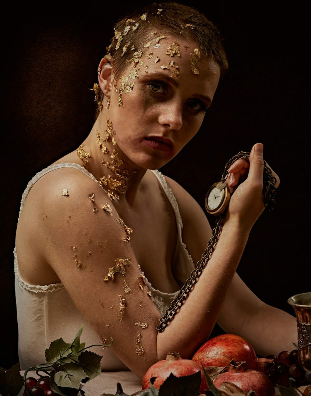 woman in white sleeveless dress holding silver ring