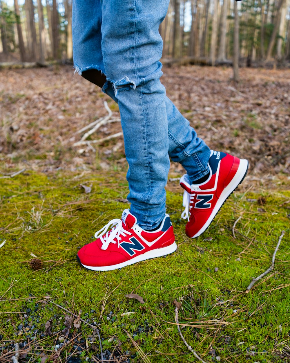 person in blue denim jeans and blue and white nike sneakers