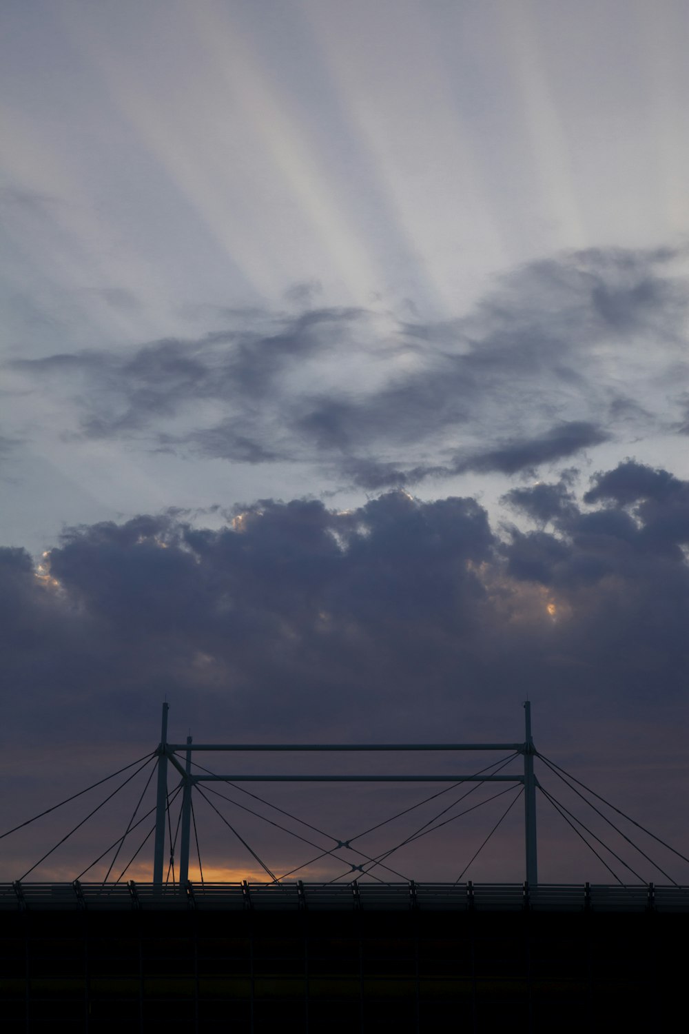 black metal bridge under white clouds