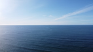 blue ocean under blue sky during daytime