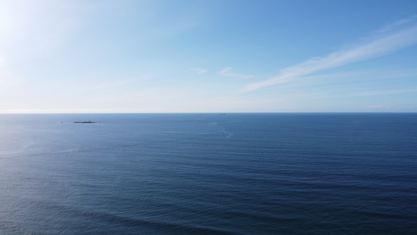 blue ocean under blue sky during daytime