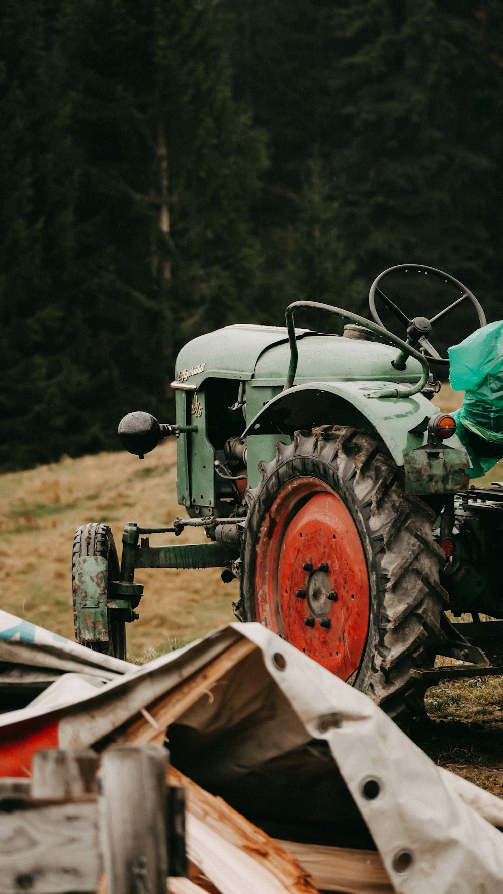 green and red tractor on brown field during daytime