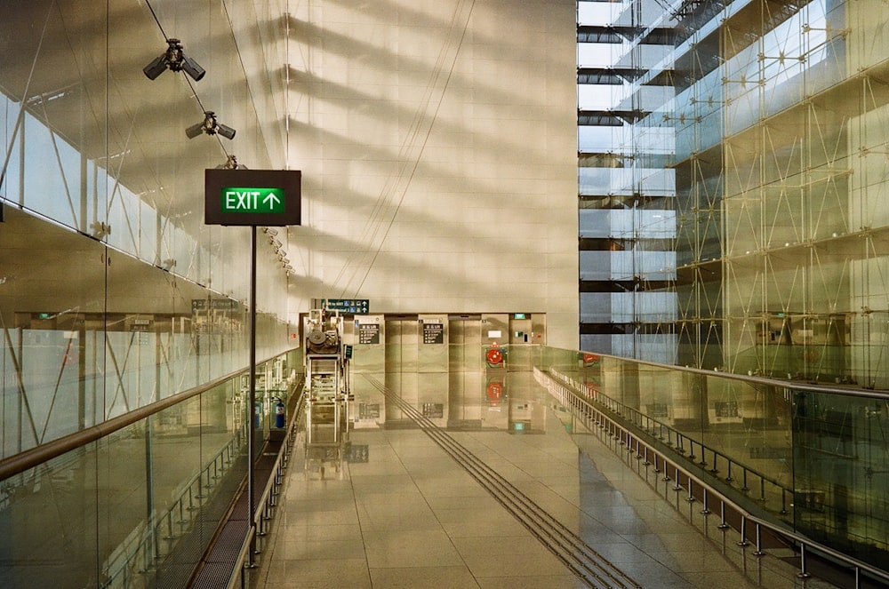 white and gray building with green and white sign