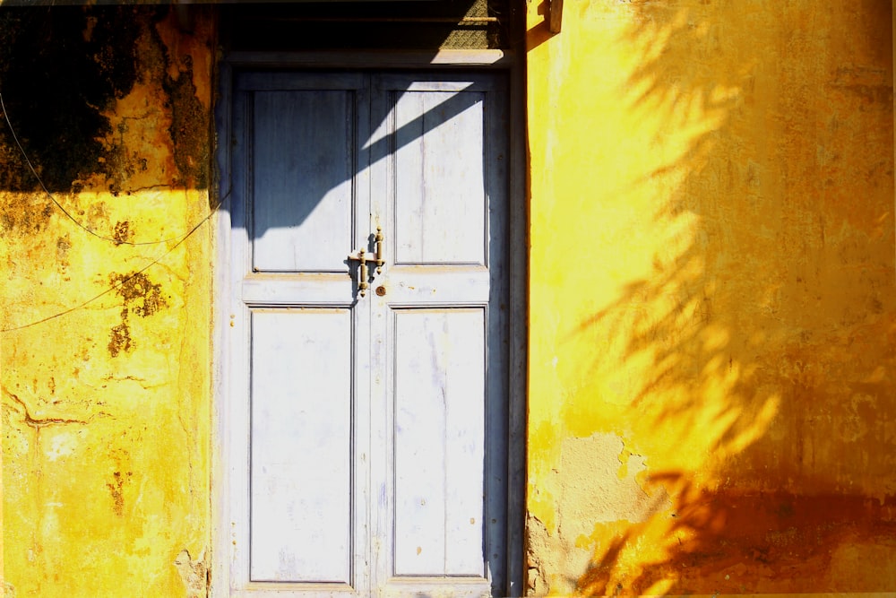 white wooden door with yellow wall