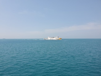 Happy travelers boarding a comfortable ferry under a clear blue sky.
