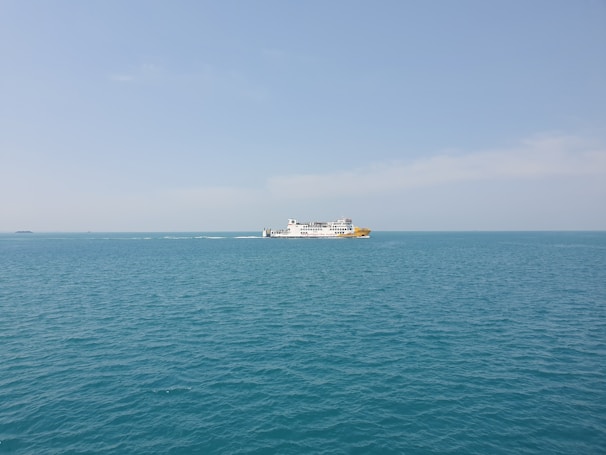Happy travelers boarding a comfortable ferry under a clear blue sky.
